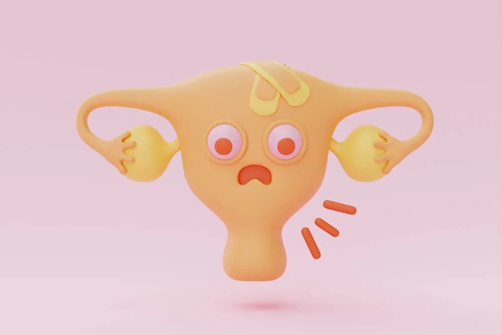 A cartoon 3D uterus character with a worried face and a bandage on its forehead, drawn on a pink background